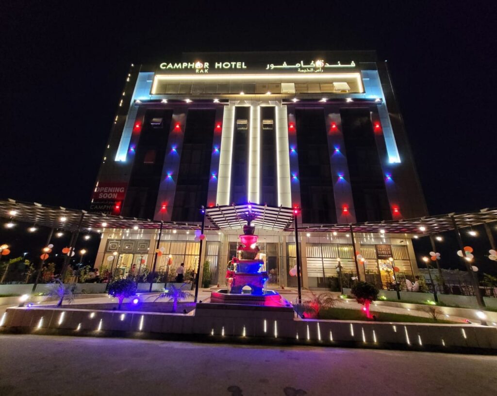 Camphor Hotel at night with the fountain in front