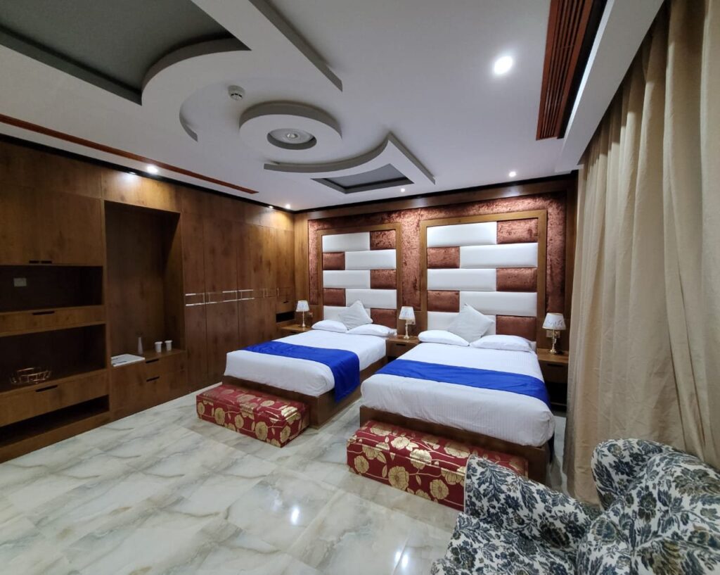 Triple room with two beds and seating